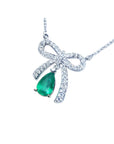 18K white gold bow-tie necklace with a pear-shaped deep green emerald.