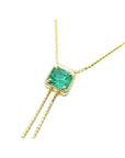 14K gold lariat necklace with a square emerald-cut natural Muzo emerald, milgrain, and prongs.