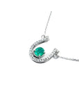 14K white gold horseshoe necklace with oval emerald and natural diamonds.