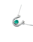 14K white gold horseshoe necklace with oval emerald and natural diamonds.