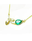 1.66 carat pear-cut natural emerald necklace in 14K yellow gold with diamond accents and leaf design.