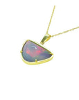 Handcrafted 14K yellow gold necklace with a free-form Ethiopian opal pendant, showcasing vibrant red and orange fire.