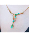 A left side view of a 14k yellow-gold necklace with Muzo emeralds and diamonds gemstones on a person's neck