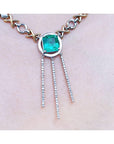 A closer left side view of a kisses and hugs necklace with a square natural Colombian emerald prong set