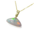 4.81 ct. Ethiopian Welo opal pendant with full play of colors, dangling from a 14k gold chain.