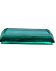 3.13 carat baguette cut Colombian emerald with sparkling bluish-green color.