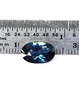 3.04 ct. deep blue-green oval cut natural Australian loose sapphire next to a ruler.