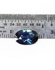 3.04 ct. deep blue-green oval cut natural Australian loose sapphire next to a ruler.