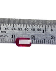 Ruby gemstone on a ruler for size reference