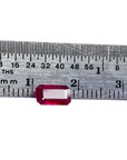 1.08 carat emerald cut Burma ruby with deep rich red color, measured on a ruler.