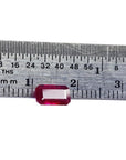 1.08 carat emerald cut Burma ruby with deep rich red color, measured on a ruler.