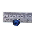 Loose round cut blue sapphire Sri Lanka, on a ruler for size reference