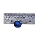2.39 ct. loose round natural deep blue sapphire from Sri Lanka, shown with a ruler for scale.