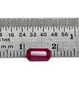 0.94 carat natural Burma ruby, emerald cut, vibrant red, displayed on a ruler.