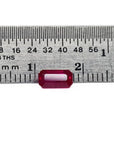 0.94 carat natural Burma ruby, emerald cut, vibrant red, displayed on a ruler.