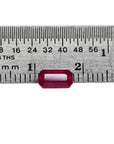 0.94 carat natural Burma ruby, emerald cut, vibrant red, displayed on a ruler.