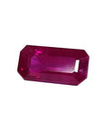 Sparkling 0.97 carat natural Burma ruby, rich red emerald cut, on a white background.
