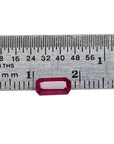Ruby gemstone on a ruler for size reference