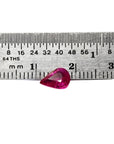 1.09 carat loose natural Burmese ruby, pear shape, sparkling medium red, shown with ruler for scale.