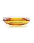 Vibrant 4.05 ct. natural yellow sapphire, emerald-cut, on a white background.