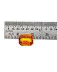 2.96 ct. loose natural yellow Madeira sapphire, radiant cut, displayed next to a ruler.