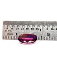 3.51 ct. natural medium pink oval sapphire with intense brilliance next to a ruler.