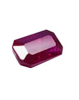 0.95 carat natural Burma ruby gemstone with a vibrant red hue and emerald cut.
