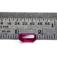 Loose ruby Burma natural gemstone emerald cut, on a ruler for scale