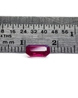 0.95 carat natural Burma ruby, emerald cut, displayed next to a ruler for scale.