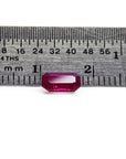 0.95 carat natural Burma ruby, emerald cut, displayed next to a ruler for scale.