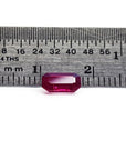 0.95 carat natural Burma ruby, emerald cut, displayed next to a ruler for scale.