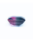7.75 ct. emerald-cut Brazilian watermelon tourmaline gemstone with vibrant red-orange and deep bluish-green bicolor.