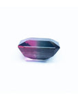7.75 ct. emerald-cut Brazilian watermelon tourmaline gemstone with vibrant red-orange and deep bluish-green bicolor.