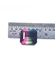 7.75 ct. emerald-cut Brazilian watermelon tourmaline, vibrant red-orange to deep bluish-green, next to a ruler.