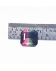 7.75 ct. emerald-cut Brazilian watermelon tourmaline, vibrant red-orange to deep bluish-green, next to a ruler.
