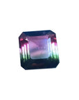 7.75 ct. emerald-cut Brazilian watermelon tourmaline gemstone with vibrant red-orange and deep bluish-green hues.