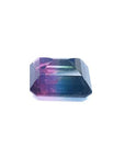 7.75 ct. emerald-cut Brazilian watermelon tourmaline gemstone with vibrant red-orange and deep bluish-green bicolor.