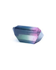 Loose 6.55 ct. emerald-cut Brazilian watermelon tourmaline, showing red, green, and blue hues.