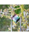Loose 6.55 ct. emerald-cut watermelon tourmaline, red to green, held by tweezers.