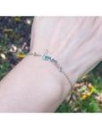 Emerald Love Bracelet: 14K white and yellow gold with a round cut Colombian emerald.