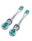 Pair of Love Knot emerald earrings left side top view on a white background