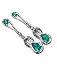 Pair of Love Knot emerald earrings pear cut in white gold on a white background