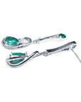Pair of 14K white gold love knot earrings with pear-shaped Colombian emeralds.