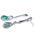 Pair of 14K white gold love knot earrings with pear-shaped Colombian emeralds.