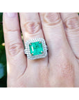 4.14 ct GIA-certified F1 Colombian emerald ring with diamonds in 14K white gold on a hand.