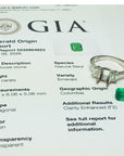 Emerald ring with GIA report on a white background