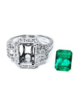 18K white gold engagement ring setting with diamond halo and baguette side diamonds, next to a vibrant emerald.