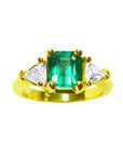 18k yellow gold emerald three stone ring for women with side trillion cut natural diamonds.