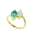 This stunning You and Me ring showcases a marquise-cut emerald paired with a natural diamond accent.