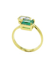 A you and me natural colombian emerald and princess cut diamonds engagement ring made of 18k yellow gold.